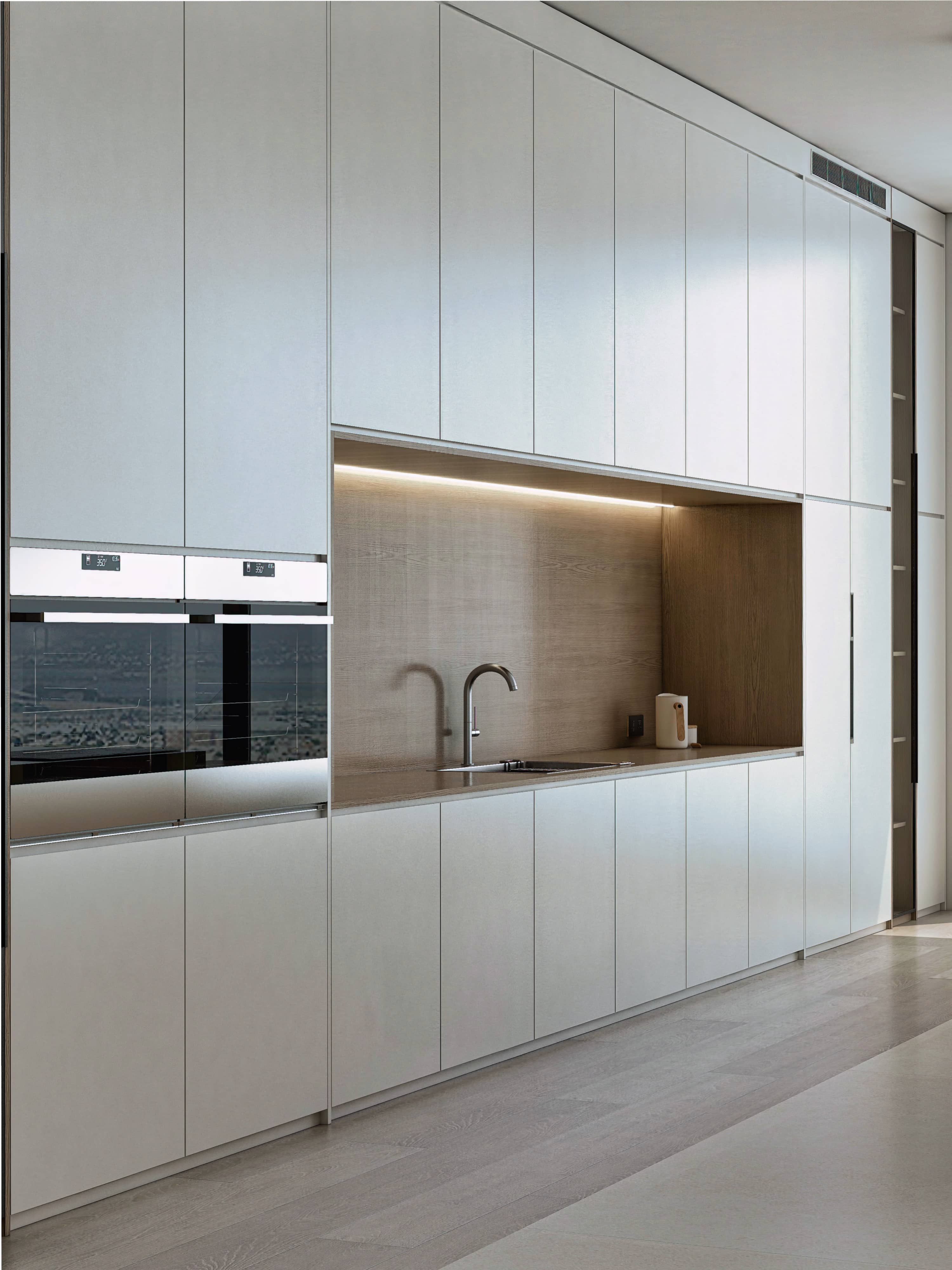 3D rendering of floor-to-ceiling white kitchen cabinetry with a backlit oak niche, built-in ovens and integrated sink, New York penthouse
